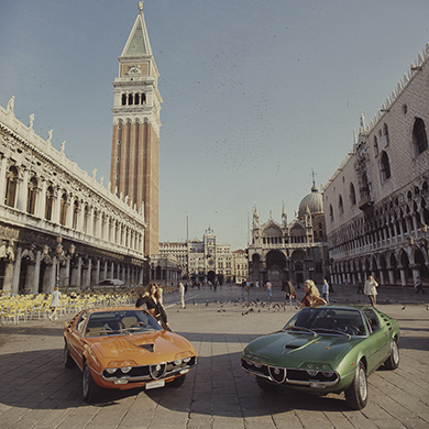 Photo of two 1970s Alfa Romeo cars in St. Mark's Square in Venice
