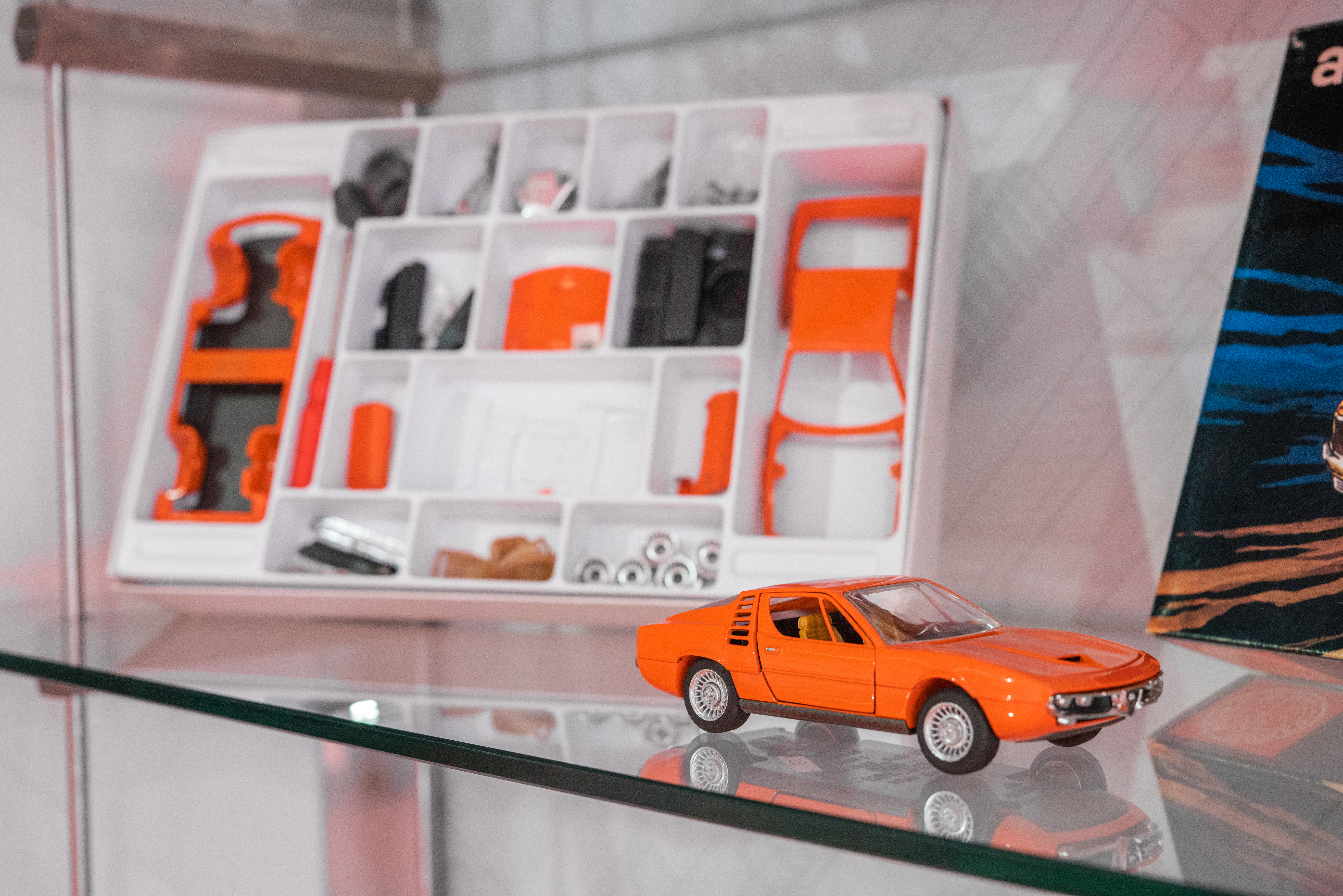 Photo of a little model of a orange Alfa Romeo car