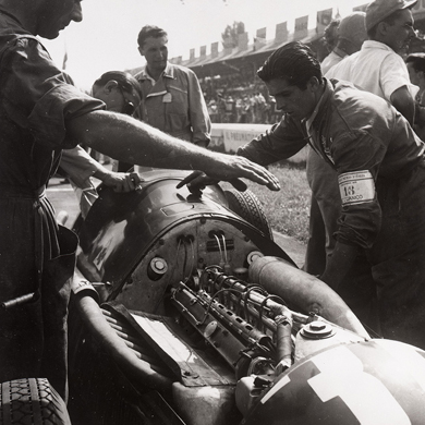 Photos of mechanics fixing a single-seater