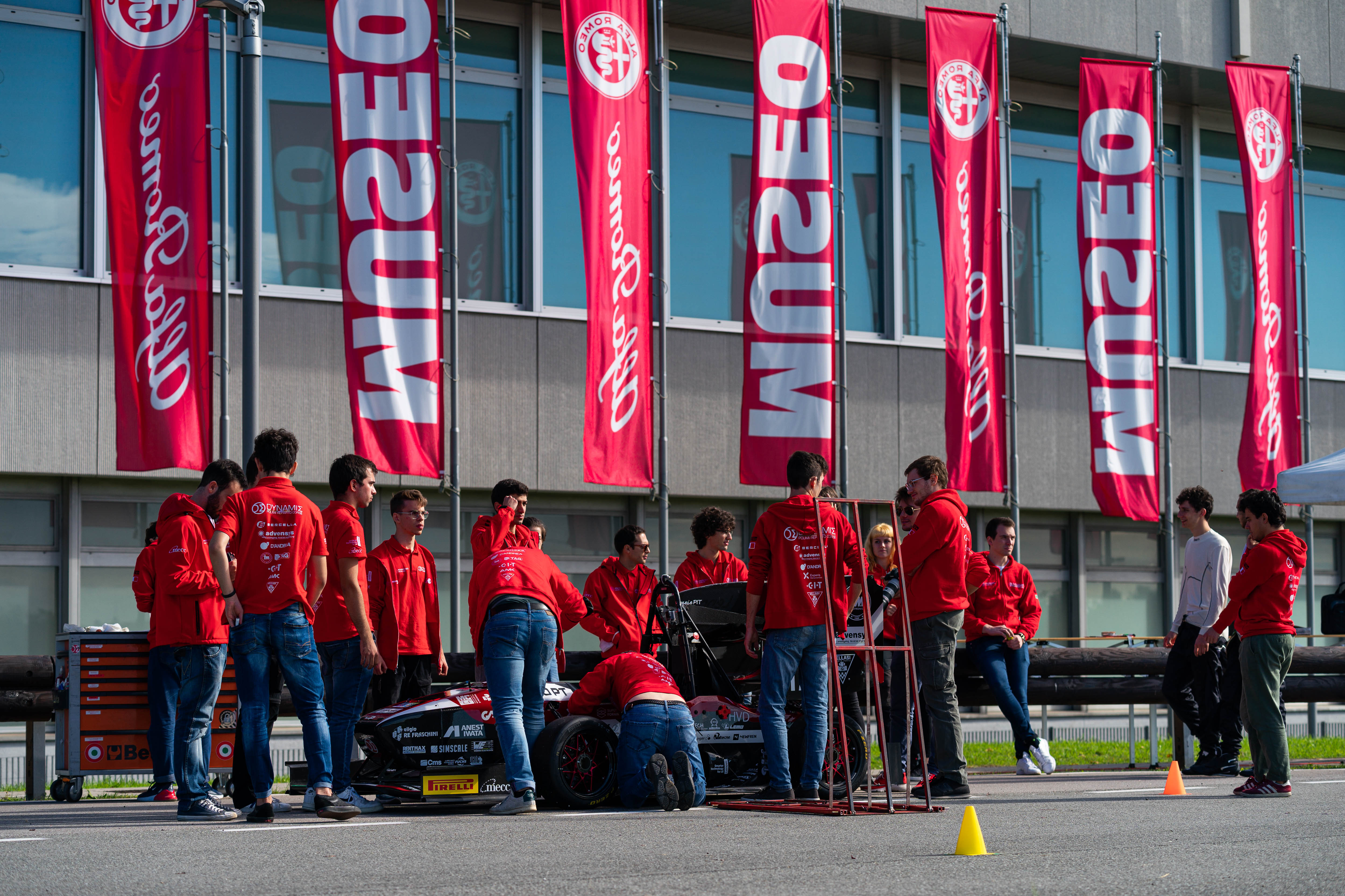 Photos of the Milan Polytechnic's racing team analyzing a single-seater formula 1 car